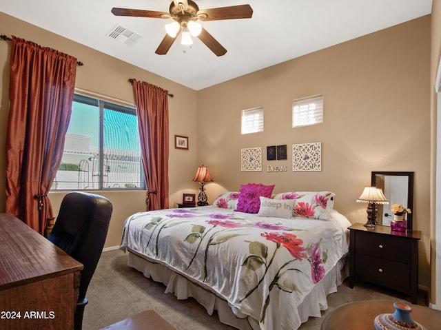 carpeted bedroom with multiple windows and ceiling fan