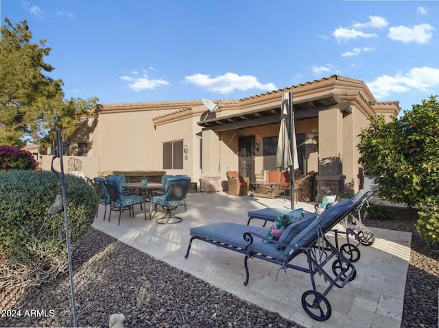 rear view of house featuring a patio