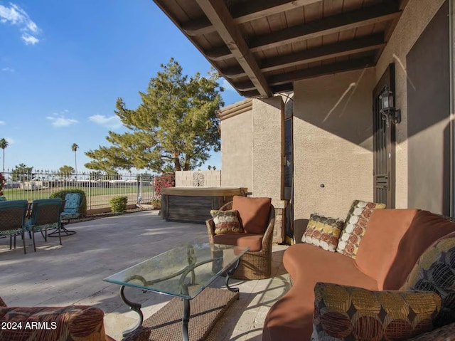 view of patio / terrace featuring outdoor lounge area and a hot tub