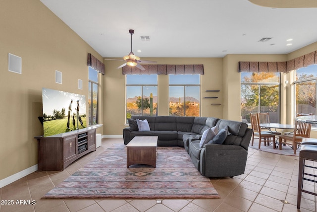 living room featuring ceiling fan and light tile patterned floors