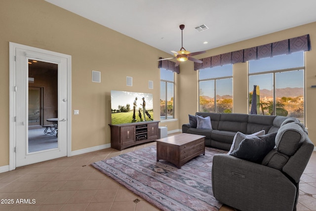 tiled living room featuring a mountain view and ceiling fan