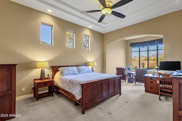 carpeted bedroom with a tray ceiling