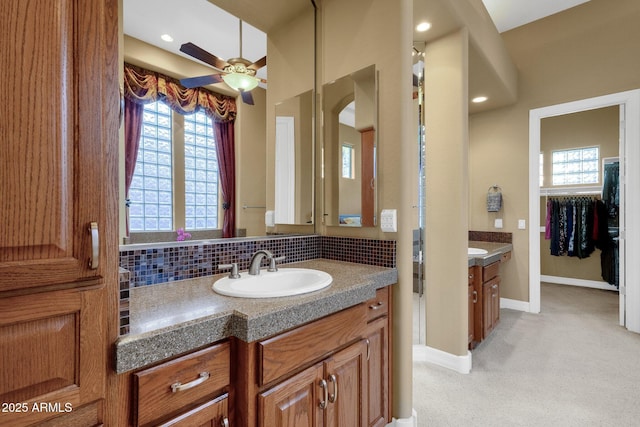 bathroom with tasteful backsplash, vanity, and a wealth of natural light