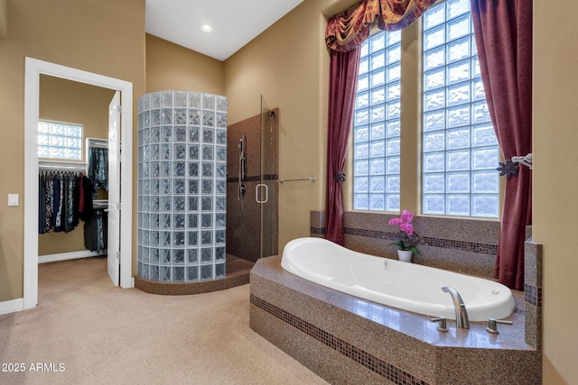 bathroom featuring a healthy amount of sunlight and separate shower and tub