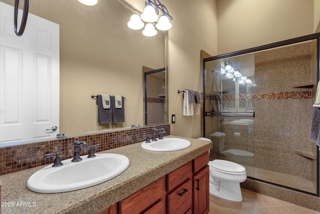 bathroom featuring walk in shower, vanity, toilet, and decorative backsplash