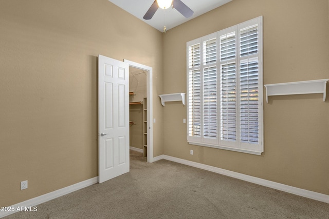 carpeted empty room with ceiling fan