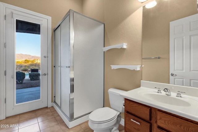 bathroom featuring tile patterned floors, toilet, an enclosed shower, vanity, and a mountain view