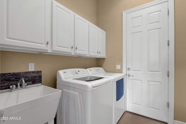 laundry room with tile patterned flooring, cabinets, washer and clothes dryer, and sink