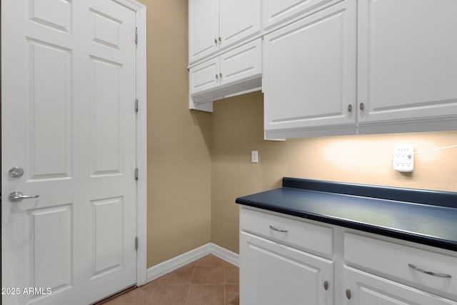 kitchen featuring white cabinetry and light tile patterned flooring