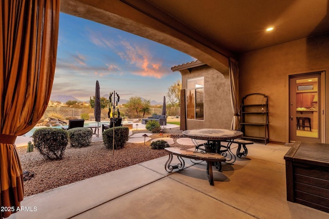 patio terrace at dusk featuring an outdoor hangout area