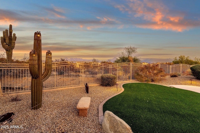 view of yard at dusk