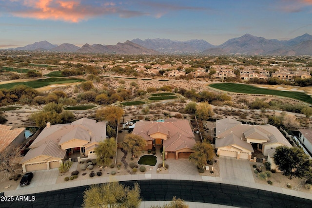 aerial view at dusk featuring a mountain view