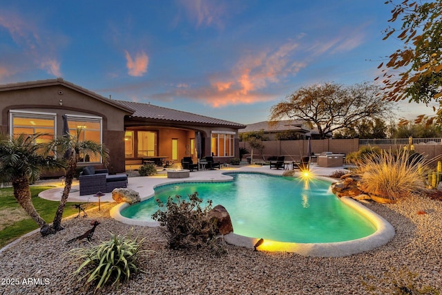 pool at dusk featuring a patio area