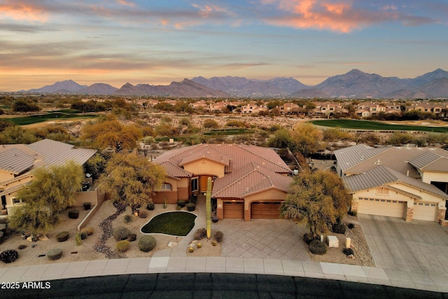 aerial view at dusk featuring a mountain view