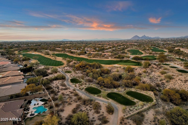 aerial view at dusk featuring a mountain view