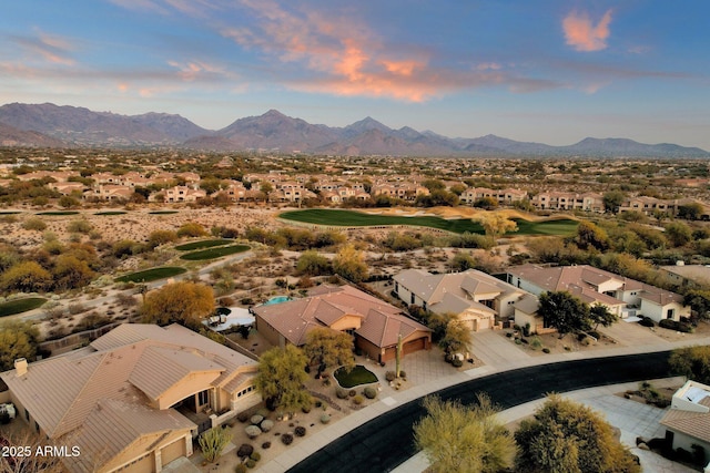 aerial view at dusk featuring a mountain view