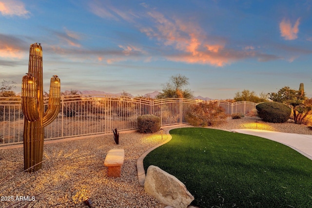 view of yard at dusk