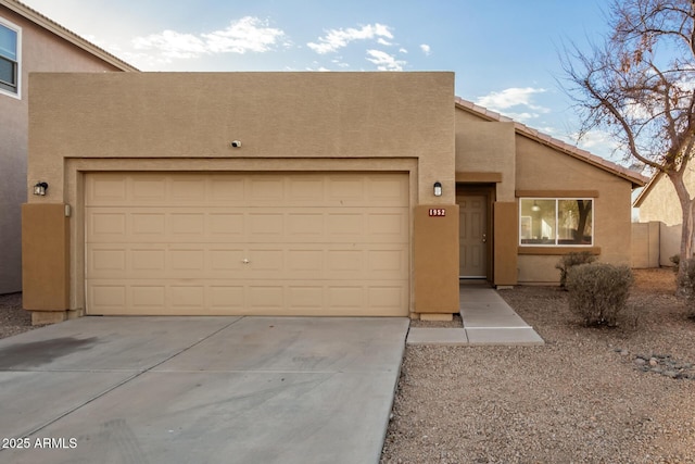 pueblo-style home featuring a garage