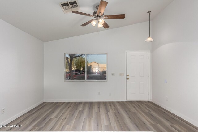 unfurnished room with ceiling fan, light hardwood / wood-style floors, and vaulted ceiling