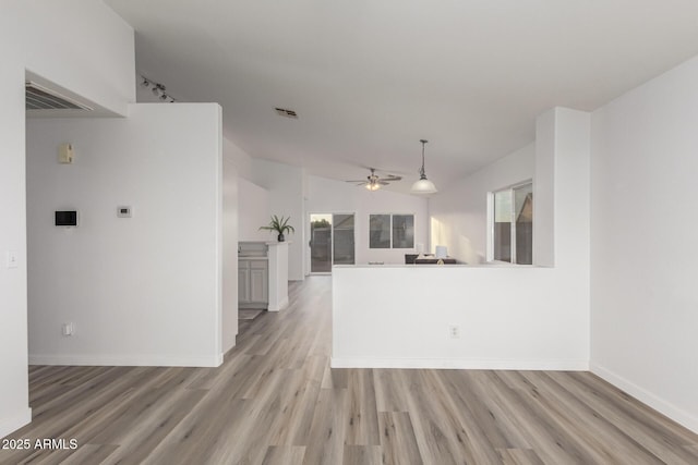 kitchen with a healthy amount of sunlight, ceiling fan, light hardwood / wood-style floors, and lofted ceiling