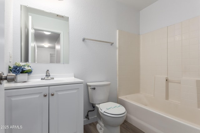 full bathroom with hardwood / wood-style floors, vanity, toilet, and tub / shower combination