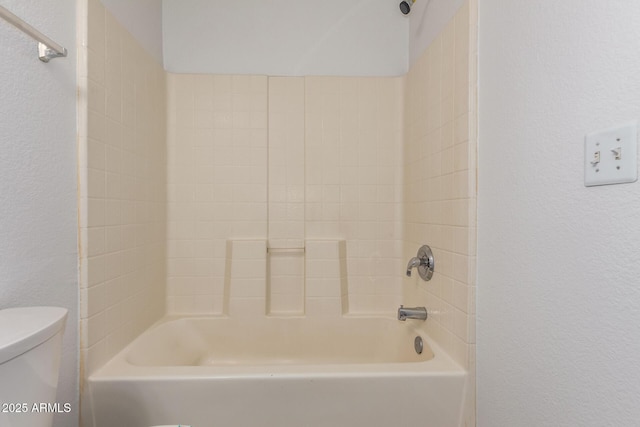 bathroom featuring toilet and tub / shower combination