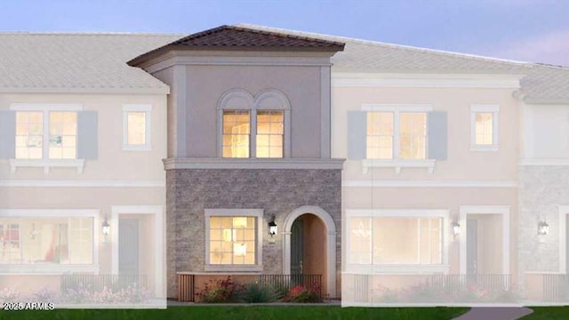 view of front of property with stucco siding and stone siding