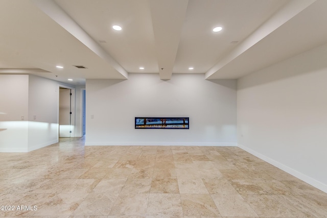 finished basement with baseboards, visible vents, and recessed lighting