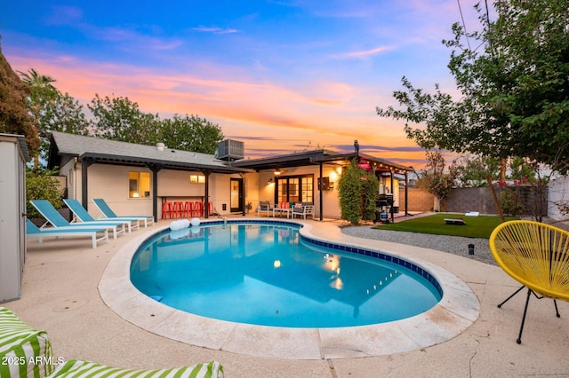 4020 N 34th St, Phoenix, AZ 85018 - view of pool with a lawn, outdoor dry bar, a patio area, a fenced in pool, and cooling unit