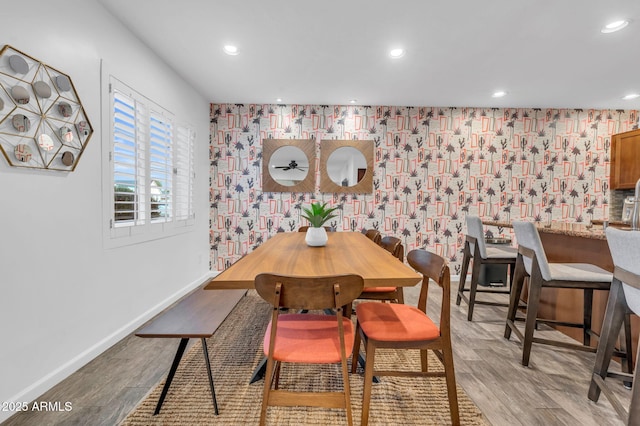4020 N 34th St, Phoenix, AZ 85018 - dining space with light wood-style flooring, an accent wall, recessed lighting, wallpapered walls, and baseboards