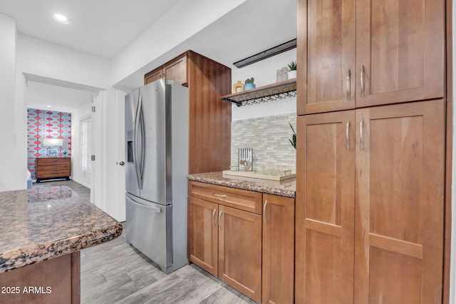 4020 N 34th St, Phoenix, AZ 85018 - kitchen featuring brown cabinetry, tasteful backsplash, stainless steel fridge with ice dispenser, light wood finished floors, and dark stone counters