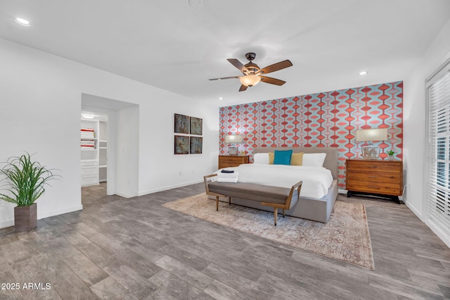 4020 N 34th St, Phoenix, AZ 85018 - bedroom with wood finished floors, baseboards, a walk in closet, ceiling fan, and recessed lighting