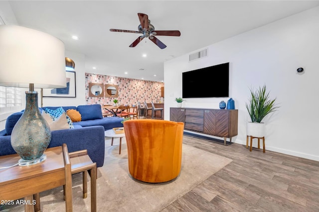 4020 N 34th St, Phoenix, AZ 85018 - living room with an accent wall, a ceiling fan, baseboards, wood finished floors, and visible vents