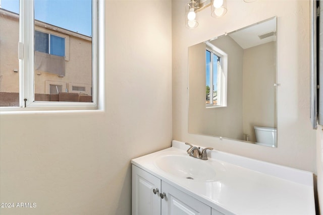 bathroom featuring vanity and toilet