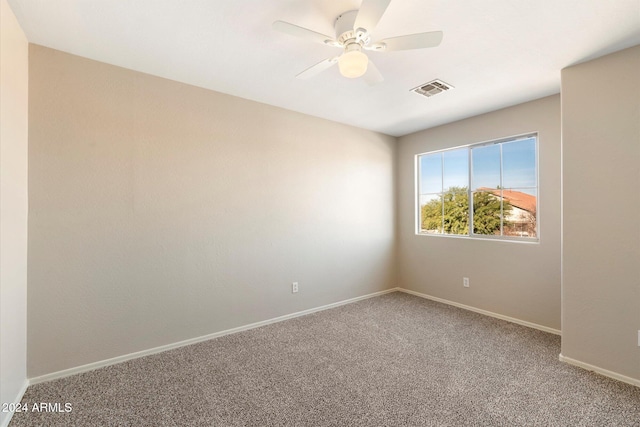 carpeted spare room with ceiling fan