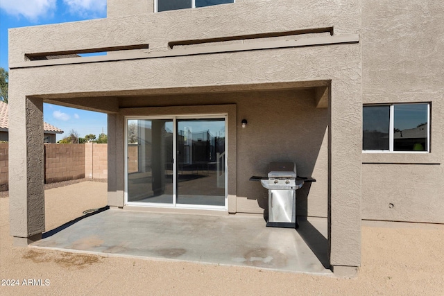 view of exterior entry featuring a patio area