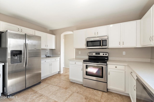 kitchen with white cabinets and appliances with stainless steel finishes