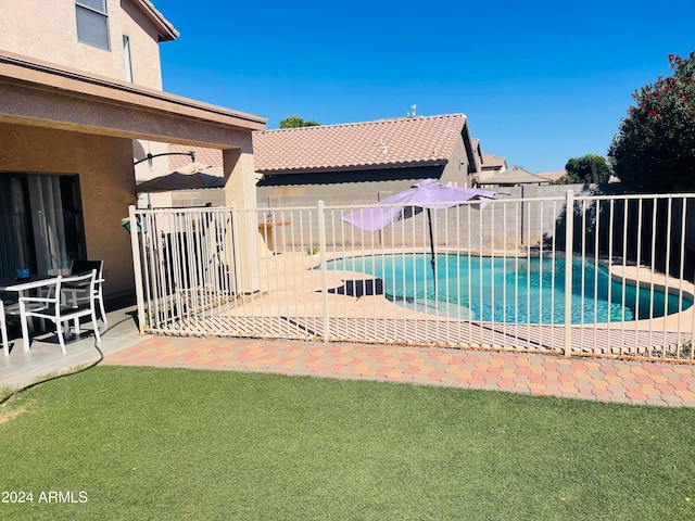 view of swimming pool featuring a patio area