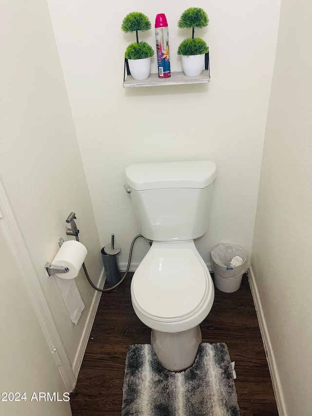 bathroom featuring hardwood / wood-style floors and toilet