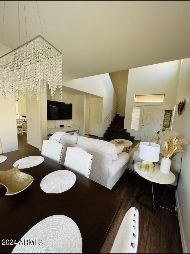 living room with dark hardwood / wood-style floors and a chandelier