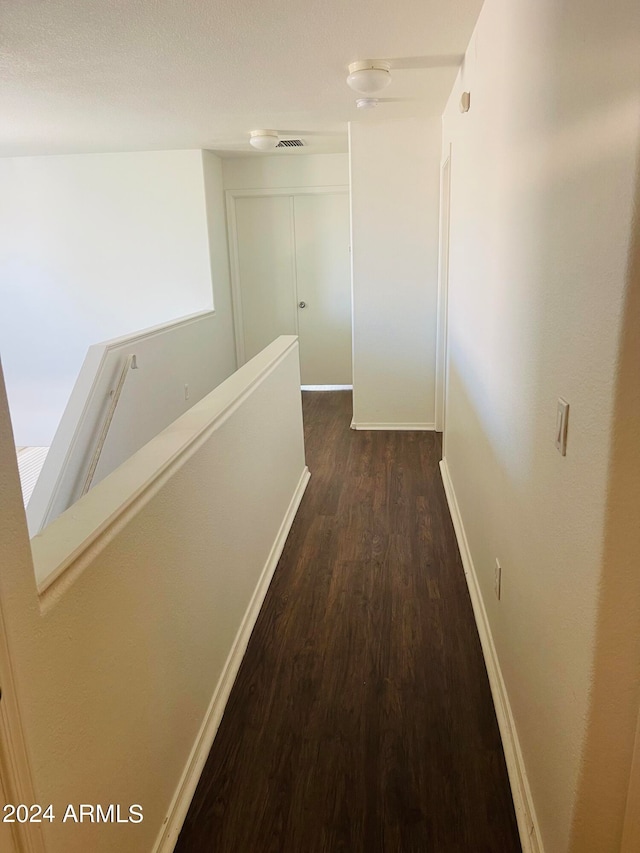 corridor featuring dark wood-type flooring