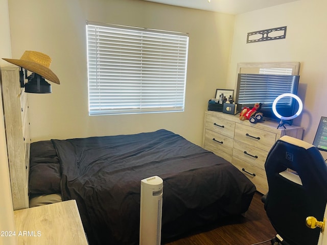 bedroom with dark hardwood / wood-style floors