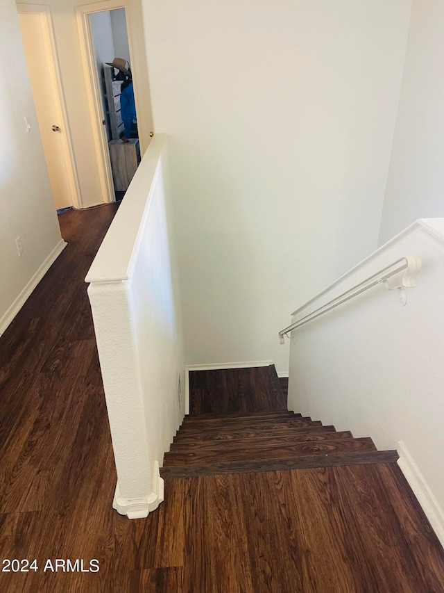 stairway featuring hardwood / wood-style floors