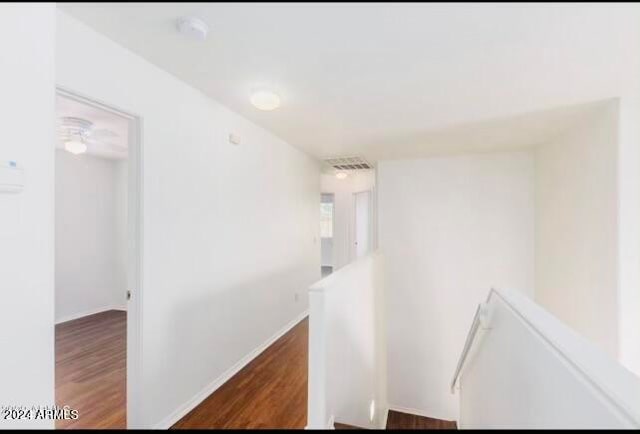 corridor featuring dark wood-type flooring