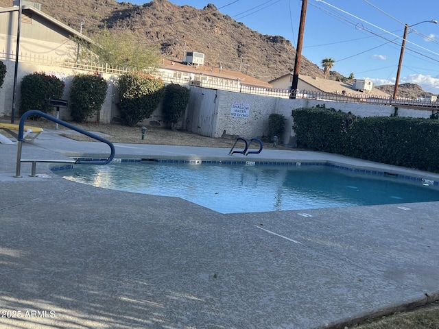 view of swimming pool with a mountain view