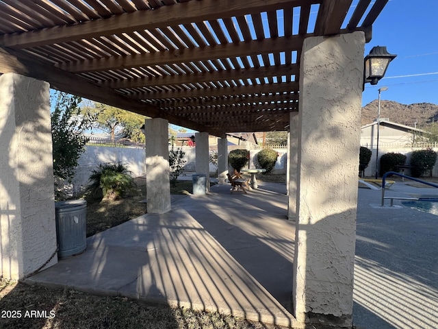 view of patio featuring a mountain view and a pergola