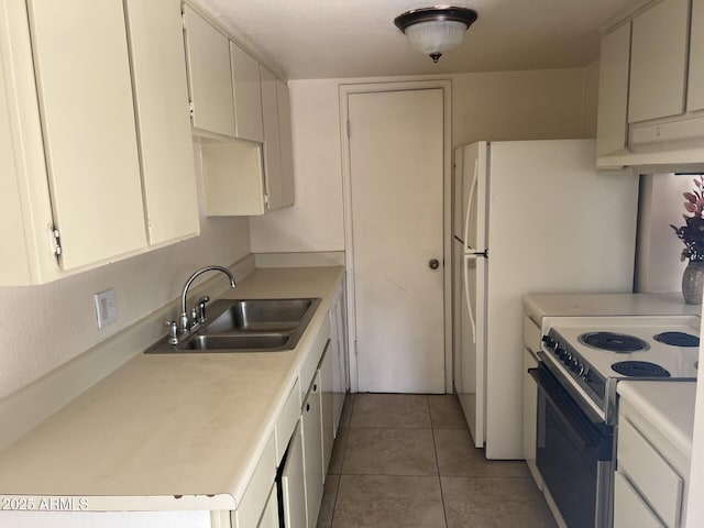 kitchen featuring white cabinetry, sink, electric range, and light tile patterned floors