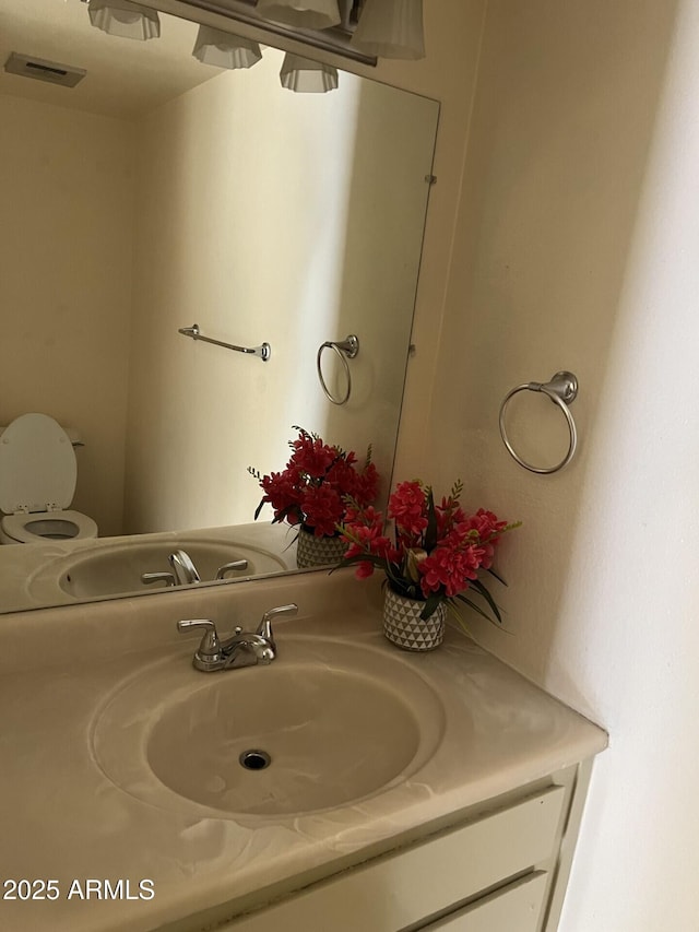 bathroom with vanity and toilet