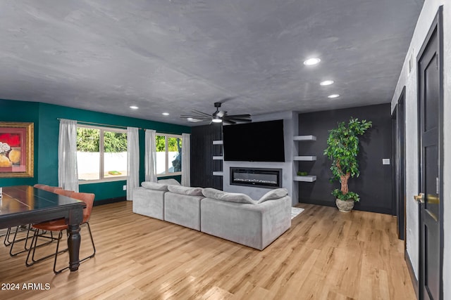 living room featuring ceiling fan and light wood-type flooring