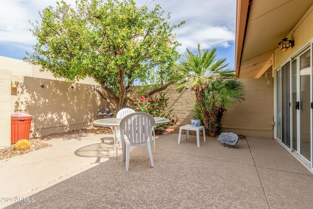 view of patio featuring outdoor dining space and a fenced backyard